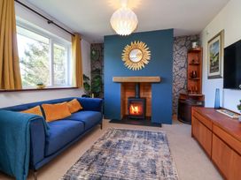 A living room with a fireplace and sofa at Hillsview in Combe Martin