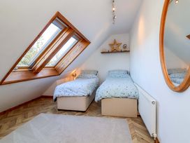 A bedroom with two beds and a window at Hillsview in Combe Martin