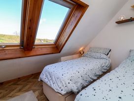 A bedroom with two beds and a window at Hillsview in Combe Martin