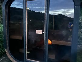 An outdoor sauna with a glass door at Hillsview in Combe Martin