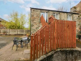 An outdoor area with a table and chairs at First Floor Apartment in Tremadog