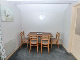 A dining room with a table and chairs at First Floor Apartment in Tremadog