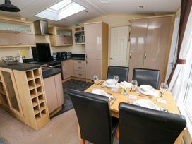 A dining room with a table and chairs at Reef Retreat in Little Haven
