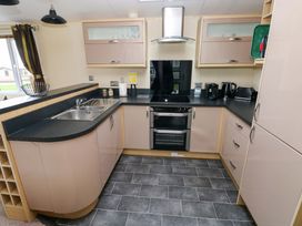 A kitchen with sink, oven and countertop at Reef Retreat in Little Haven