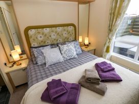 A bedroom with a bed and pillows at Reef Retreat in Little Haven