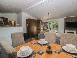 A dining room with a table set for meals at Treetops Beech Hill 13, Fallbarrow Park near Bowness-On-Windermere