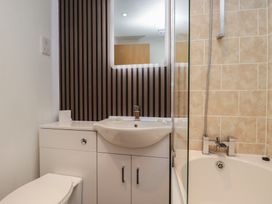 A bathroom with a toilet sink and shower at Treetops Beech Hill 13, Fallbarrow Park near Bowness-On-Windermere