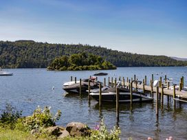 A view of boats at a dock by the water at Treetops, Beech Hill 13, Fallbarrow Park near Bowness-On-Windermere
