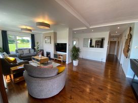 A living room with sofas coffee table tv and plants at Ashlea in Launceston