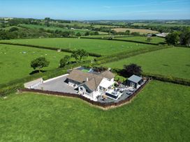 A house with a fenced garden in a rural area surrounded by green fields at Ashlea in Launceston