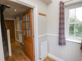 A hallway with a door, radiator, and coat hooks at Crispin in Lucker
