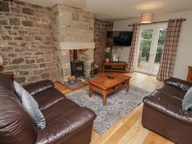 A living room with a fireplace and television at Crispin in Lucker