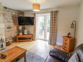 A living room with a television and sofa at Crispin in Lucker