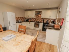 A kitchen with a dining table and appliances at Crispin in Lucker