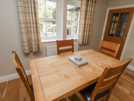 A dining room with a wooden table and chairs at Crispin in Lucker