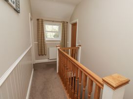 A hallway with a staircase and window at Crispin in Lucker
