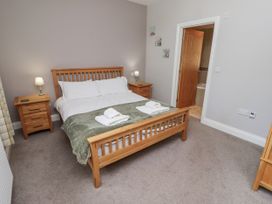 A bedroom with a bed and nightstands at Crispin in Lucker