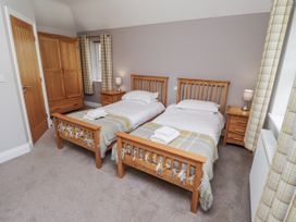 A bedroom with two beds and a wardrobe at Crispin in Lucker
