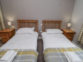 A bedroom with two single beds and bedside tables at Crispin in Lucker