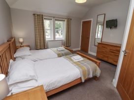 A bedroom with twin beds and a television at Crispin in Lucker