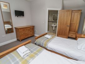 A bedroom with two beds and a dresser at Crispin in Lucker