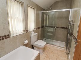 A bathroom with a shower and tub at Crispin in Lucker