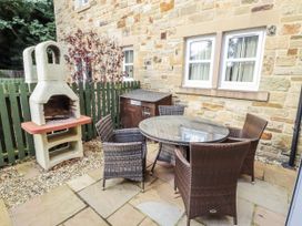 An outdoor seating area with a table and chairs at Crispin in Lucker