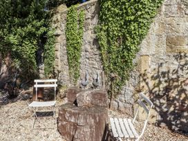 A garden area with chairs and a wooden table at Crispin in Lucker