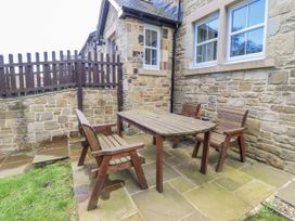 An outdoor seating area with a wooden table and chairs at Crispin in Lucker