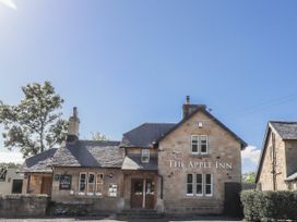 A building with a sign in front at The Apple Inn in Lucker