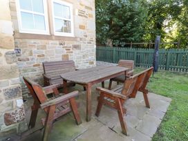 A table and chairs in a garden at Pippin Lucker