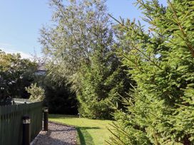 A garden with trees and a gravel pathway at Pippin Lucker