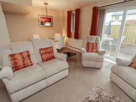 A living room with sofa and armchairs at Ahoy in Seahouses