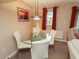 A dining room with a glass table and chairs at Ahoy in Seahouses