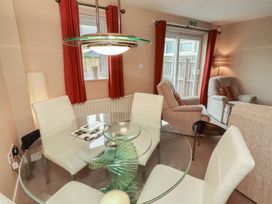A dining room with a glass table and chairs at Ahoy, Seahouses