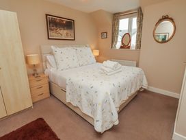 A bedroom with a bed and furniture at Ahoy in Seahouses
