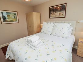 A bedroom with a bed and wardrobe at Ahoy in Seahouses