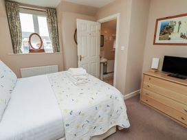 A bedroom with a bed and television at Ahoy in Seahouses