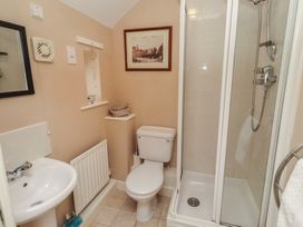A bathroom with a shower, sink, and toilet at Ahoy in Seahouses
