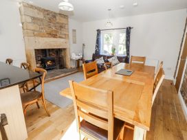 A dining room with a wooden table and chairs at Bramley in Lucker