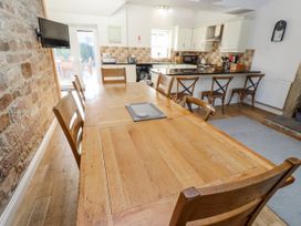 A dining room with a large wooden table at Bramley Lucker
