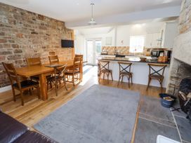 A kitchen with a dining table and chairs at Bramley in Lucker