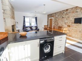 A kitchen with an island and seating area at Bramley in Lucker