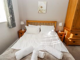 A bedroom with a bed and nightstands at Bramley in Lucker