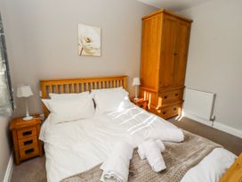 A bedroom with a bed and wardrobe at Bramley in Lucker