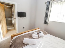 A bedroom with a bed and towels at Bramley in Lucker