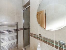 A bathroom featuring a shower, towel rail, and mirror at Bramley in Lucker