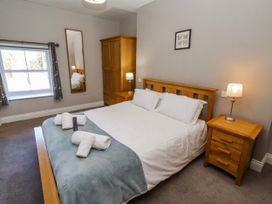 A bedroom with a bed and furniture at Bramley in Lucker
