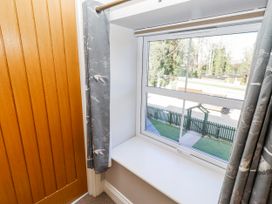 A bedroom window with curtains and a view at Bramley in Lucker