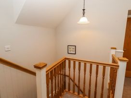 A staircase with a light fixture and a picture frame at Bramley in Lucker